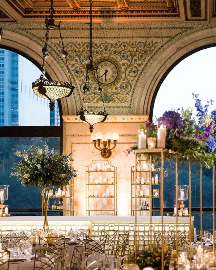 Chameleon Chairs at around tables with elevated floral arrangements at a Chicago wedding reception.
