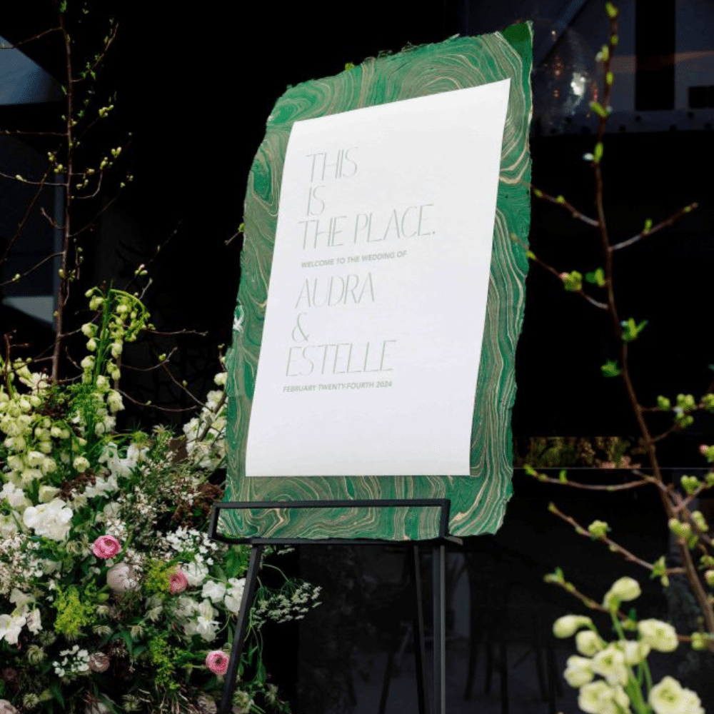 Green and white wedding welcome sign.